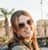 Happy female tourist with photo camera standing on Morocco tours