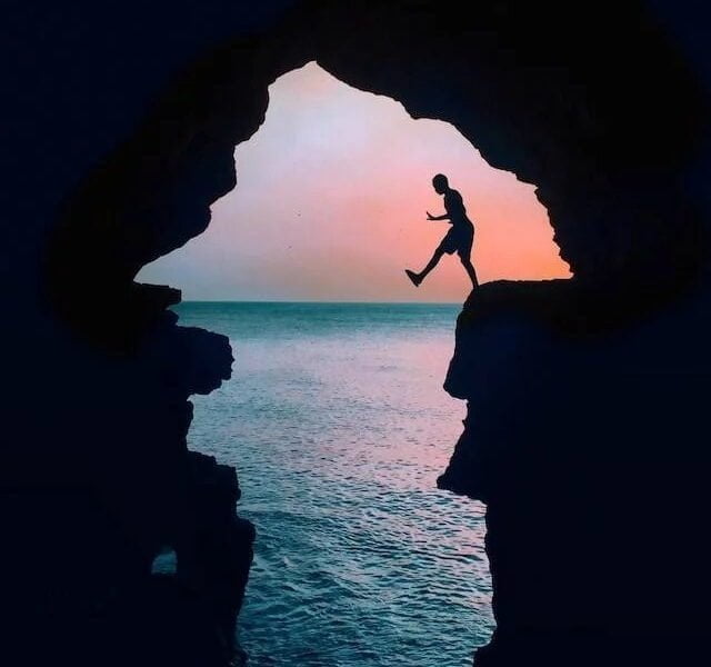 silhouette photography of a man on cliff in tangier city