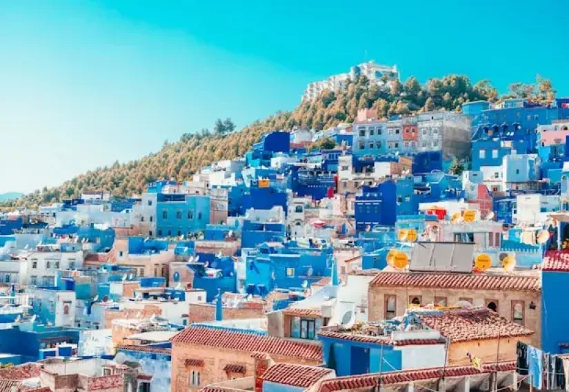 Blue and white in chechaouen painted houses on the cliff.