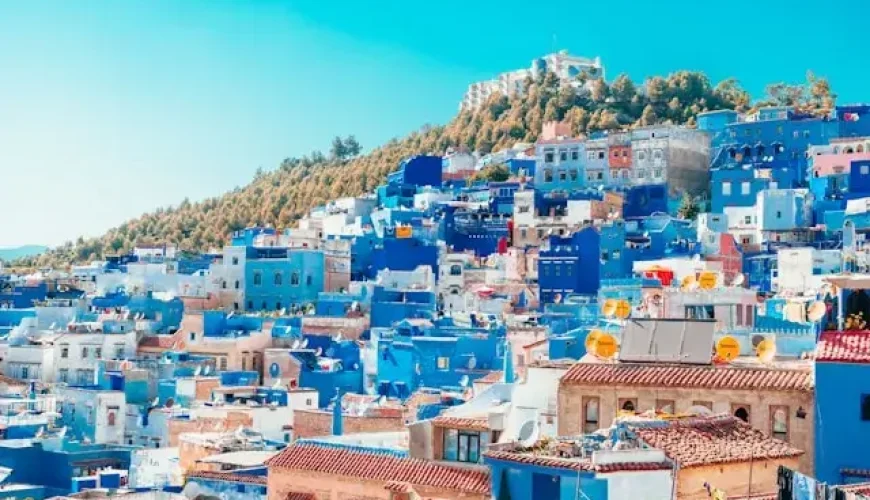 Blue and white in chechaouen painted houses on the cliff.