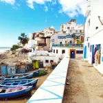 Boat docked near houses and body of water