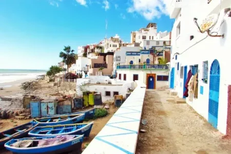 Boat docked near houses and body of water