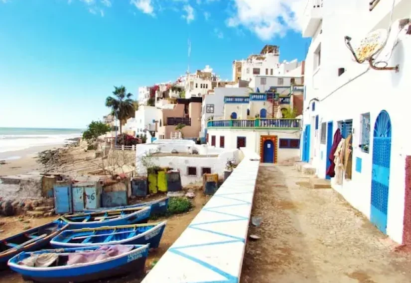 Boat docked near houses and body of water