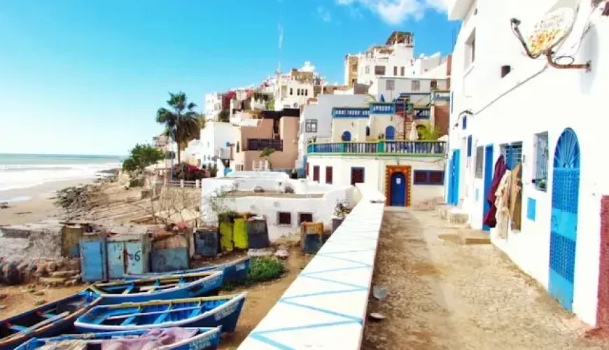 Boat docked near houses and body of water