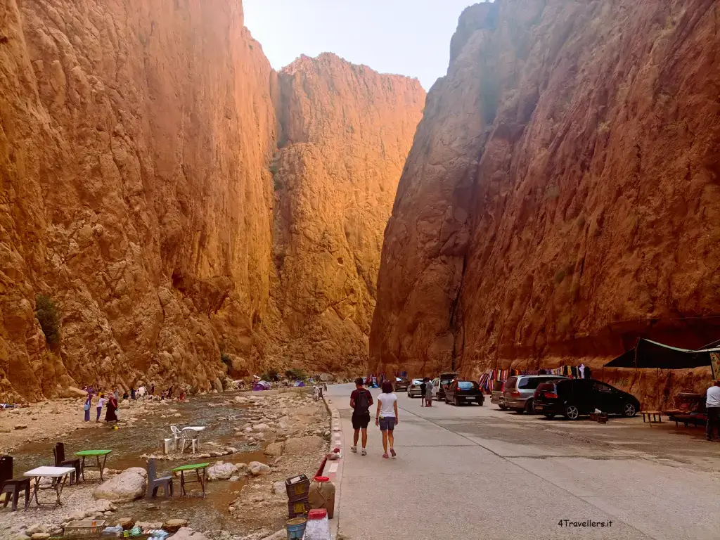 Tourists exploring the towering cliffs of the Todra Gorge, a popular destination for visitors to Morocco.