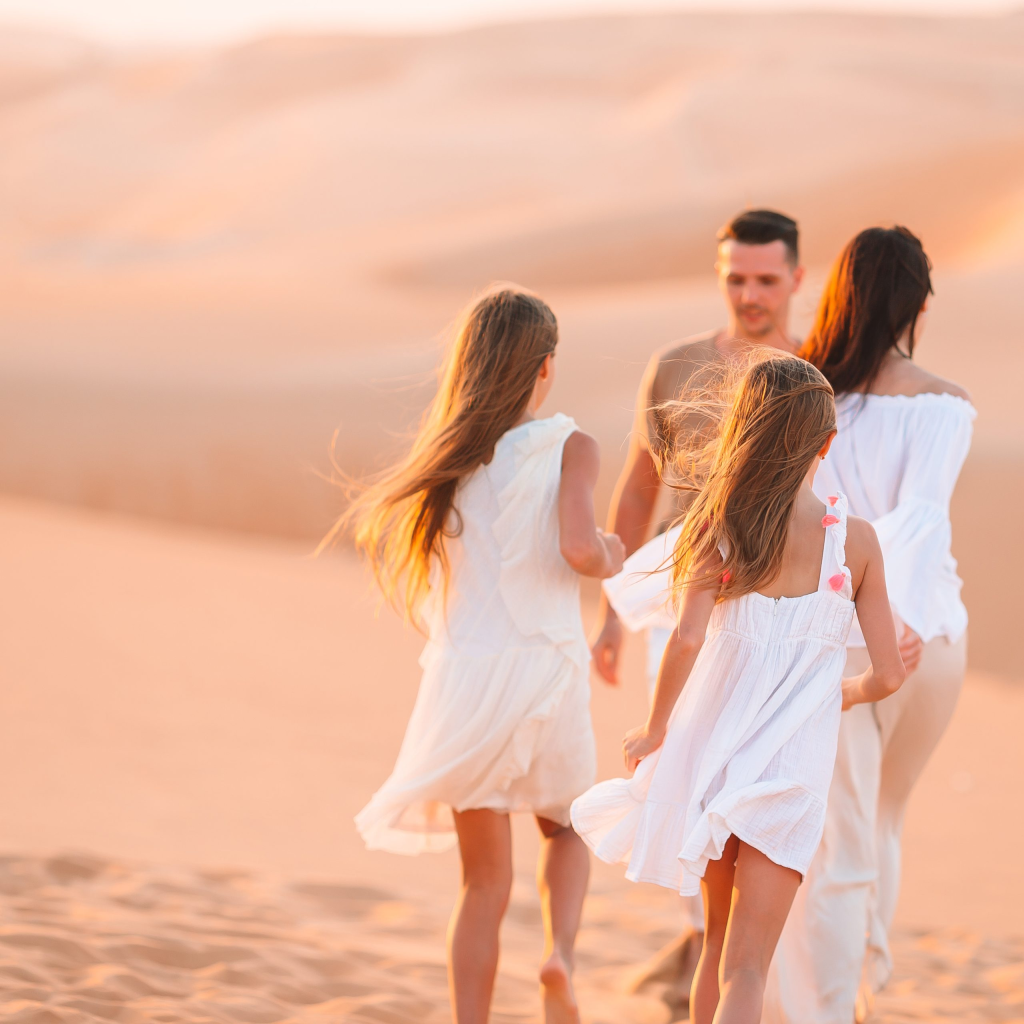 people among dunes in desert