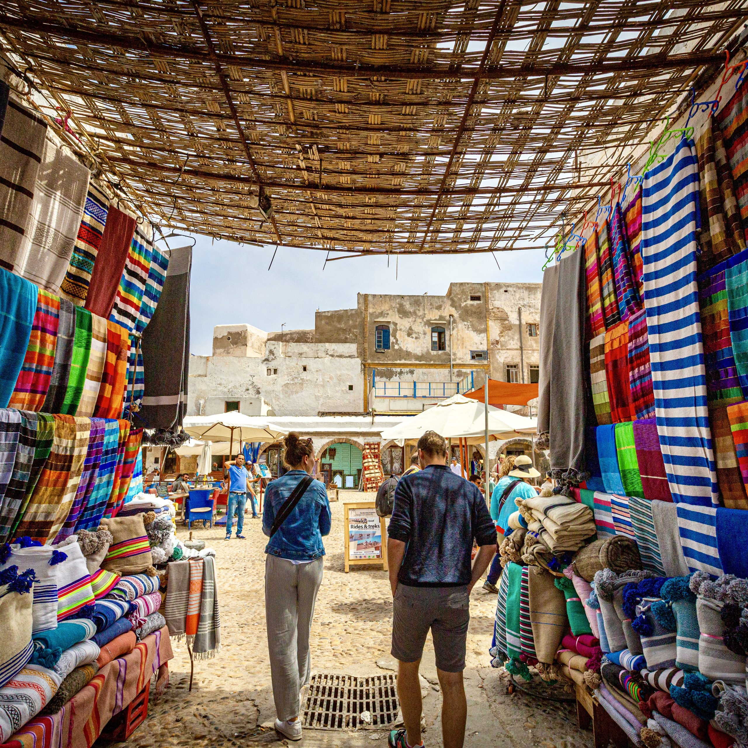 tourists walking through moroccan market of colour